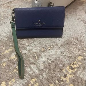 Used Kate Spade wristlet wallet. Purple and teal. Good condition